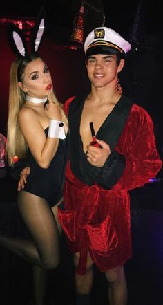 two people dressed in costumes posing for the camera