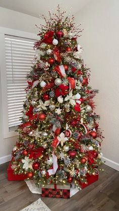 a christmas tree decorated with red, white and silver ornaments