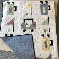 two quilts are laying on the floor next to each other and one has a blue triangle