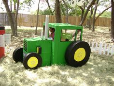 a tractor made out of cardboard sitting in the grass