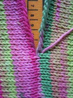 a close up view of a crocheted blanket with a measuring tape