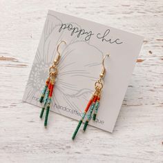 Keep your earrings game strong with our Seed Bead Rod Trio Earrings! These unique dangles feature a mix of fall colors, making them perfect for the season. With these trendy and playful earrings, you'll be sure to turn heads and add a touch of whimsy to any outfit. The handcrafted Seed Bead Rods are lightweight and chic!  Earrings created using tarnish resistant silver and gold metal. Total length/drop of earrings: approximately 2.5" Materials used are hypoallergenic. Disclaimer: materials used may discolor, fade or tarnish if exposed to moisture or chemicals. Remove prior to swimming, showering, etc. Playful Earrings, Fall Bead, Gold Bead Earrings, Stick Earrings, Chic Earrings, Earrings Beaded, Earring Tutorial, Holiday Earring, Homemade Jewelry