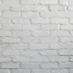 an old white brick wall with no mortars or mortars on it's sides