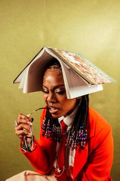 a woman with an open book on her head