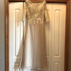 Jaeden Mother Of The Bride Dress , Lace And Chiffon With Slight Bead Work At Scoop Neck , 3/4 Sleeve And Side Zipper Size 6 In Champagne Color, Never Worn Condition With Attached Tag Embellished Mother Of The Bride Dress With 3/4 Sleeves, Embellished 3/4 Sleeve Dress For Mother Of The Bride, Embellished 3/4 Sleeve Wedding Dress, Elegant Beige Half Sleeve Dress, Elegant Beige Half-sleeve Dress, Bride Dress Lace, Mother Of The Bride Dress, Champagne Color, Dress Lace