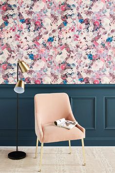 a chair and lamp in front of a floral wallpapered room with blue walls