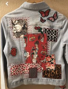 a jean jacket with patches and designs on it