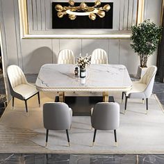 a dining room table with chairs and a painting on the wall in the back ground