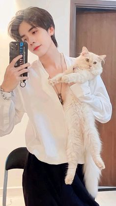 a woman taking a selfie with her cat