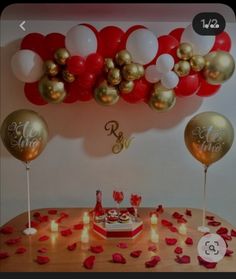 a table topped with lots of balloons and confetti