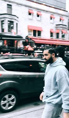 a man with a beard walking down the street