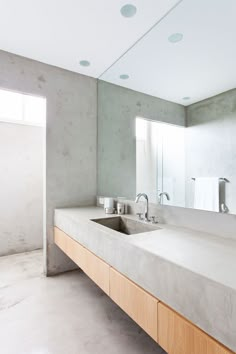 a bathroom with two sinks and mirrors in it