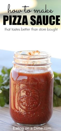 a jar filled with sauce sitting on top of a wooden table