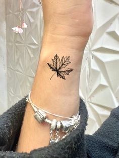 a small leaf tattoo on the ankle