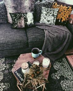 a living room filled with lots of furniture and pillows on top of a wooden table