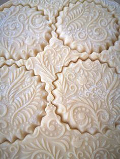 four pieces of pie sitting on top of a white table cloth covered in icing