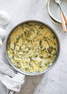 a pot filled with food next to some eggs