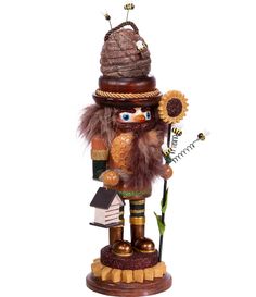 a wooden nutcracker with a hat and feather on it's head holding a flower