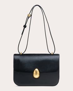 Luxury in leather, the Phoenix bag shows off a compact, top-flap silhouette detailed with gold-tone hardware and tonal stitch trim. Adjustable with a unique spherical bead pull, the slim strap can be worn across the body or carried on the shoulder for versatile appeal.Adjustable strapMagnetic closureGold-tone hardwareInterior slip pocketOuter: 100% calf leatherLining: 81% polyurethane, 13% polyester, 6% viscoseSpot cleanImported Measurements Width: 9.05in Height: 7.48in Depth: 2.16in Strap drop: Circular Economy, Baguette Bag, Silhouette Crafts, Personal Shopping, Magnetic Closure, Cloth Bags, Handbag Accessories, You Bag, Italian Leather