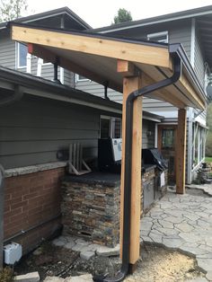 an outdoor bbq with a grill built into it's side wall and attached to the roof