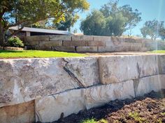 a large rock wall in the middle of a yard