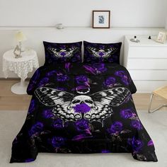 a bed with purple flowers and a butterfly on it