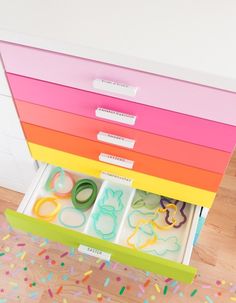 the drawers are filled with different colored paper