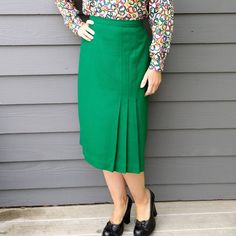 True, rich green wool or wool-blend midi skirt. No tags inside. Late 1970's/early 1980's era from the style, there is a nylon zipper in back, and a hook/bar closure. Front side kickpleat accent. Fits approximately M, waist measures 30.5", hip is 45" around, taken 9" down from front center waist. 28.25" long. Great condition, just got back from the dry-cleaner. Check out my other listings, I love to combine shipping! I cannot mark international packages as 'gift', as that is customs fraud. Dreaming of more than one item in our shop? We understand! If your multiple-item order totals $100 or more before shipping, enter coupon code MULTIDEAL at checkout and save 10%! Use the code as often as you like, and we'll keep adding new items for you to drool over. :) Green Pencil Skirt For Workwear In Fall, Retro Green Skirt For Fall, Green Lined Skirt For Office, Fitted Green Pencil Skirt For Fall, Green Lined Office Skirt, Green Knee-length Skirt For Formal Occasions, Classic Green Pleated Skirt, Retro Green Knee-length Skirt, Green Retro Knee-length Skirt