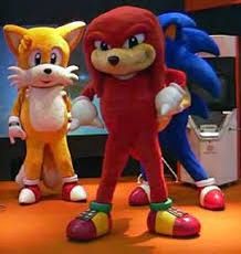 sonic the hedgehog and tails characters standing next to each other in front of a tv screen