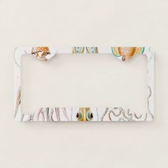 a white license plate frame with sea shells and seashells painted on the front