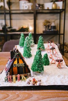 a table topped with a cake shaped like a lodge