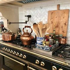 an old fashioned stove with pots and pans sitting on it's burners