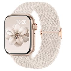 an apple watch with white braiding and flower on the front, gold case is shown