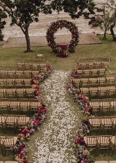 an overhead view of a wedding ceremony with flowers on the aisle and chairs lined up in rows