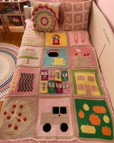 a crocheted blanket is on top of a bed with pink sheets and pillows