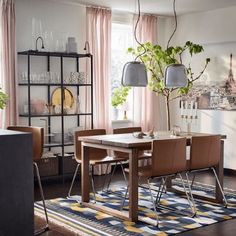 a dining room table and chairs in front of a window