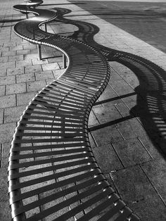 a row of benches sitting on top of a sidewalk