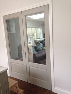 an empty room with white walls and glass doors