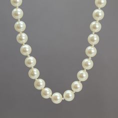 "A beautiful Signed Monet 23\" faux pearl necklace, cream color Signed Monet on The Clasp Faux 8mm Glass Pearls Gold Tone Box Clasp Hand Knotted This item is in stock and ready to ship. I found necklace in an estate sale. It is a used item. It does show some signs of wear consistent with its age. Please inspect photos closely. It is working and wearable. If you have questions please ask. I will do my best to answer them. I do not clean the jewelry while it is in my possession. The charm of vintage jewelry is the old patina and wear on the items. It is part of what makes them gorgeous! This is real vintage jewelry. Do not use liquid silver polish or harsh chemicals on pieces with stones. Those substances will cause damage. A simple silver cloth will do, taking care to avoid the stones as mu Classic Cream Pearl Necklace With Pearl Charm, Classic Cream Necklace With Pearl Chain, Classic Cream Pearl Chain Necklace, Classic Cream Pearl Jewelry, Classic Cream Round Beads Jewelry, Classic Cream Round Bead Jewelry, Cream Pearl Necklace For Formal Occasions, Formal Cream Pearl Necklace, Classic Cream Necklaces With Round Beads