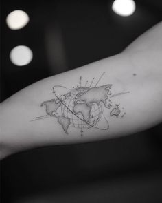 a person's arm with a world map tattoo on it