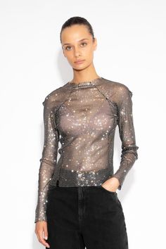 This Crystal Embellished Fishnet Long-Sleeved Top exudes an ultra-feminine aesthetic. With its impeccable craftsmanship, brilliant crystal embellishments, and daring design, this top is perfect for making a provocative and sophisticated statement. Hand sewn Centre back zip  All-over crystals Length: 56cm The model is 5ft 9 and wears a size small Gentle Dry Clean Chic Sparkling Tops For Party Season, Glamorous Stretch Mesh Top For Fall, Stretch Glamorous Mesh Top For Fall, Glamorous Sparkling Stretch Top, Glamorous Stretch Top With Sparkling Details, Black Sequined Mesh Top For Party, Glamorous Stretch Mesh Long Sleeve Top, Chic Sparkling Tops For Night Out, Glamorous Sparkling Tops For Fall