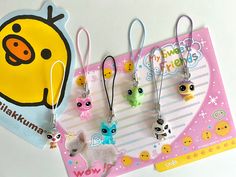 the little animals are hanging from the hooks on the clipboard, which is also attached to the keychain