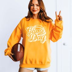 Hey there, football fan! Ready to elevate your game day style? Our Game Day Script Football Sweatshirt is the perfect way to showcase your love for the sport with a touch of elegance. Whether you're at the stadium, hosting a tailgate party, or cheering from home, this sweatshirt blends comfort with a sleek, sporty look. Crafted from ultra-soft, high-quality fabric, our Game Day Script Football Sweatshirt ensures warmth and durability throughout the season. Its relaxed fit and premium material ke Mama Crewneck, Football Sweatshirt, Games To Buy, Tailgate Party, Hot Mess, Sporty Look, Hey There, Game Day, Medium Length