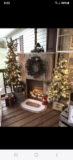 a porch decorated with christmas trees and wreaths