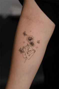 a woman's arm with flowers and butterflies tattoo on the left side of her body