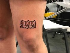 a woman's leg with a tattoo on it that reads 999 and has the word 999 written in cursive font