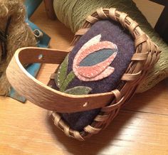 a close up of a basket on the floor with yarn