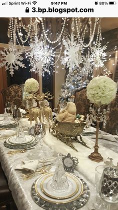 the table is set with silver and gold dishes