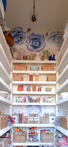 an organized pantry with lots of food and baskets on the bottom shelf, along with other items