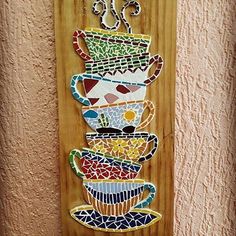 a wooden sign with coffee cups painted on it